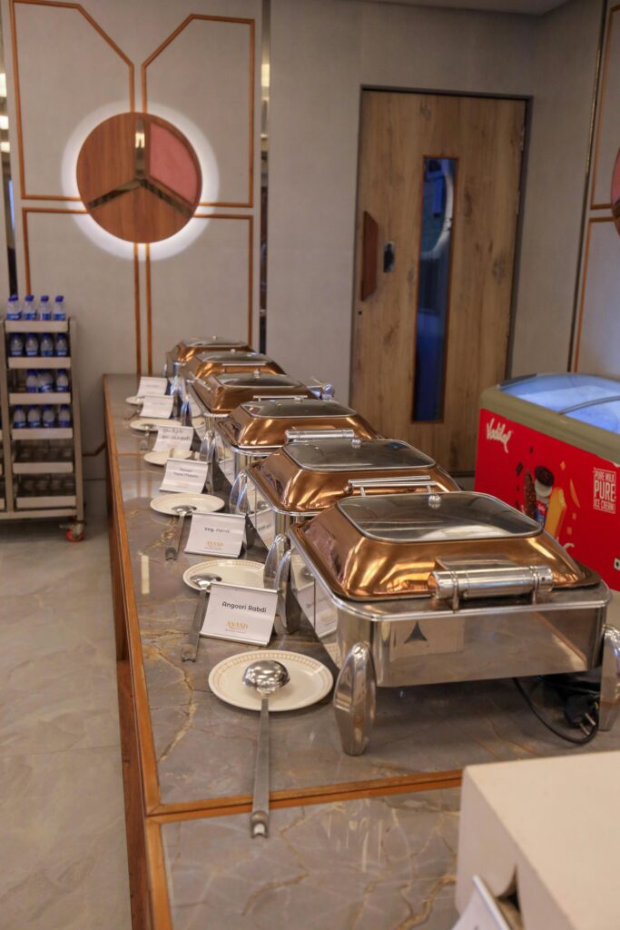 Modern indoor buffet setting with elegant chafing dishes and stylish decor.